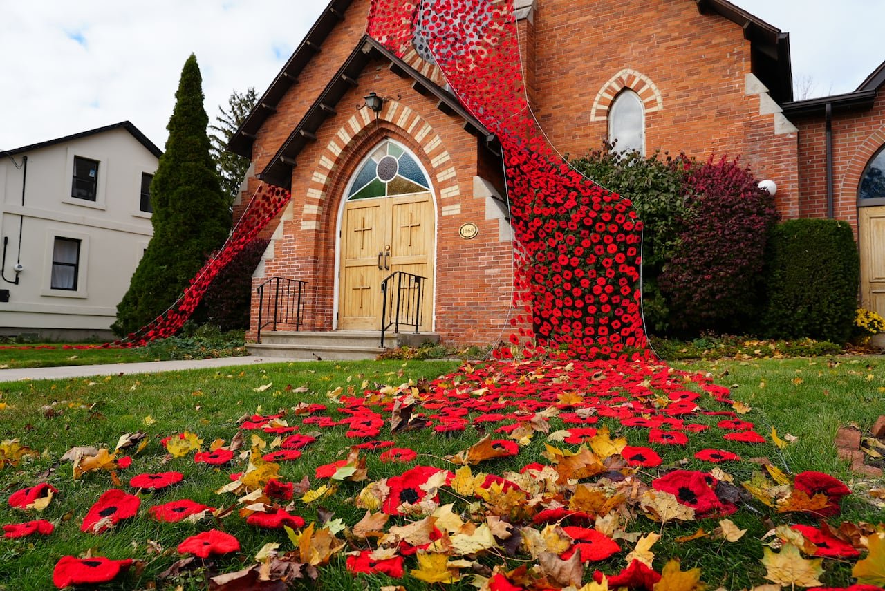 default-16 knitted poppies draping the entrance of a church
